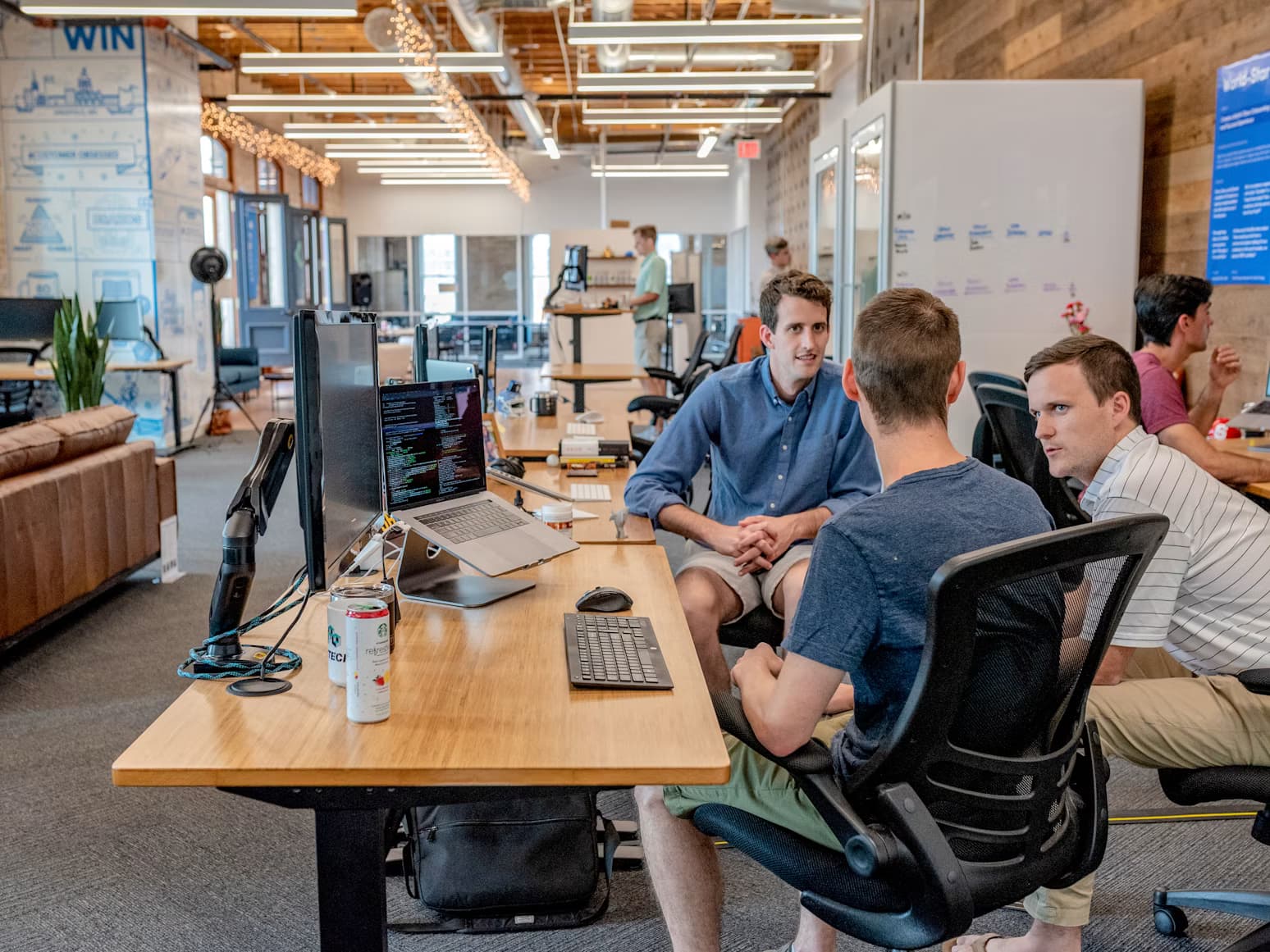 Team in conversation at a shared workspace